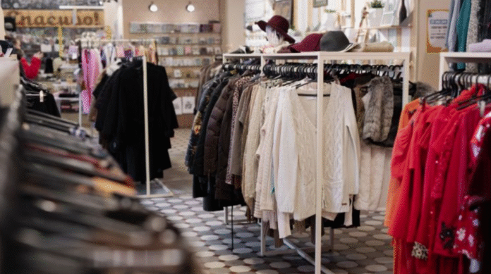 A modern office worker wearing a tailored suit with sneakers outside a glass business district tower